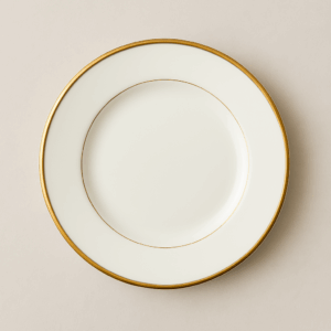 White ceramic salad / appetizer plate with a fine gold rim, ideal for upscale event rentals including weddings, galas, and private dinners—adds elegance to any table setup.