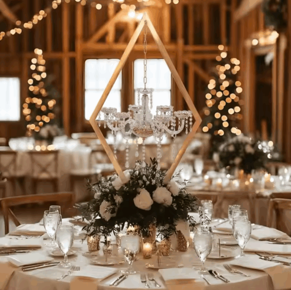 Rent elegant tabletop decor from Houston Party Rental Services, featuring a gold geometric diamond frame with a hanging crystal chandelier centerpiece. Perfect for weddings, corporate events, and upscale parties in Houston, TX. Available for rent with full-service setup, styling, and delivery.