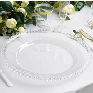 Elegant table setup featuring a clear beaded charger plate, gold flatware, Ideal for weddings, upscale dinners, and luxury events — available for rent from Houston Party Rental Services.